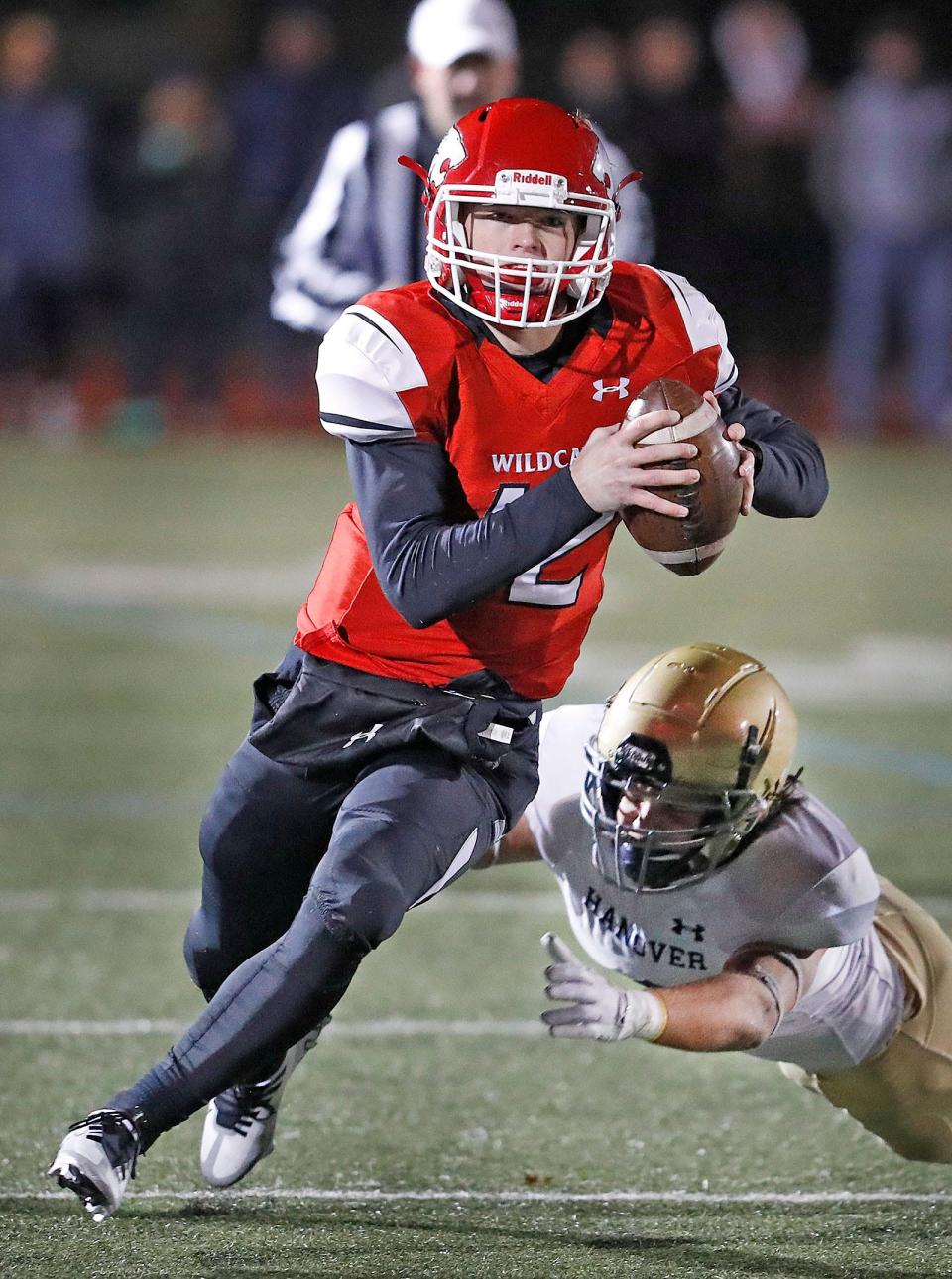 Milton QB Owen McHugh avoids a tackle out of the pocket.Milton advances to the MIAA championship with its win over Hanover 32-30 on Friday November 18, 2022.