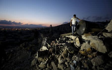 A man inspects the rubble of a Palestinian house which was destroyed by Israeli troops during an Israeli raid in the West Bank city of Jenin September 1, 2015. REUTERS/Mohamad Torokman