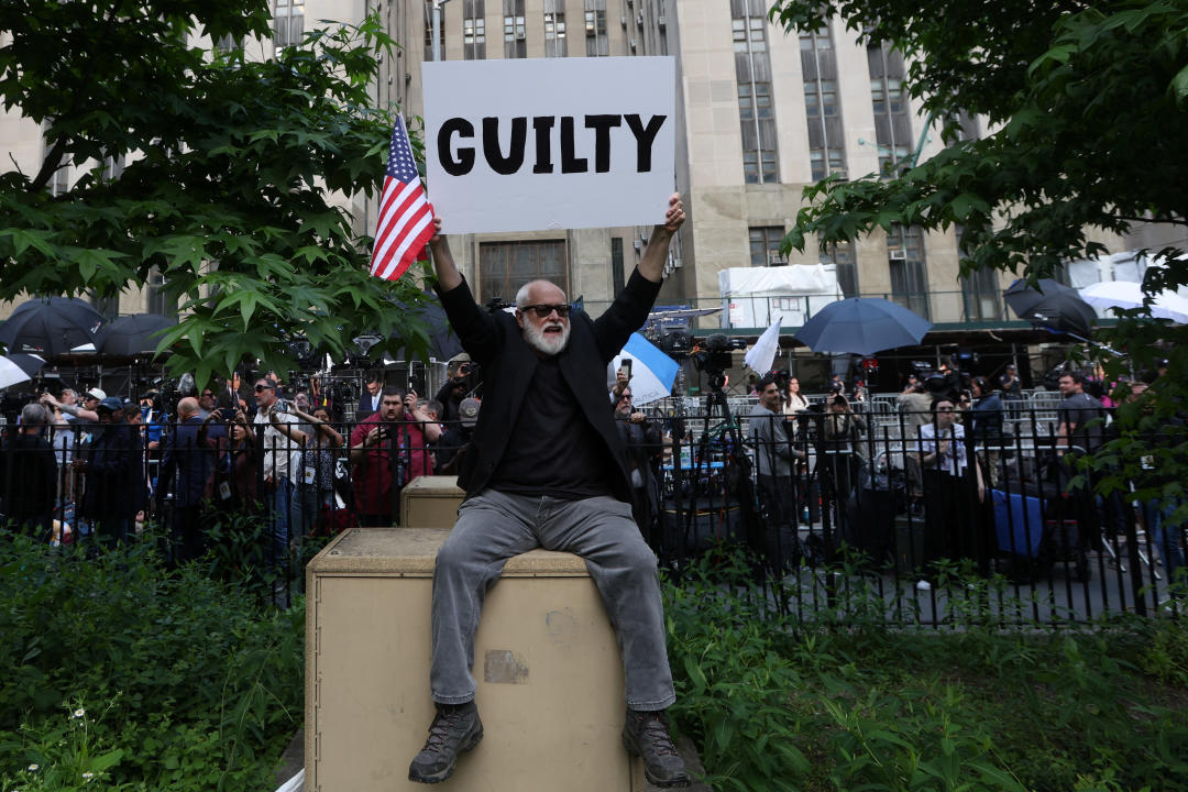 A man holds a placard outside Manhattan criminal court following the verdict in former U.S. President Donald Trump's criminal trial over charges that he falsified business records to conceal money paid to silence porn star Stormy Daniels in 2016, in New York City, U.S. May 30, 2024. (Mike Segar/Reuters)