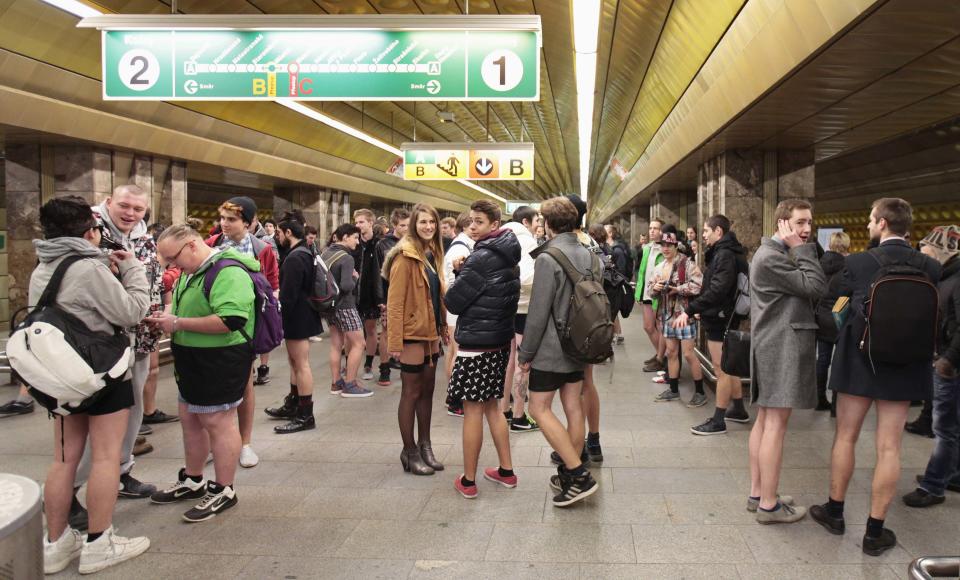 Passengers, not wearing pants, perform as they wait for a subway train during the "No Pants Subway Ride" in Prague