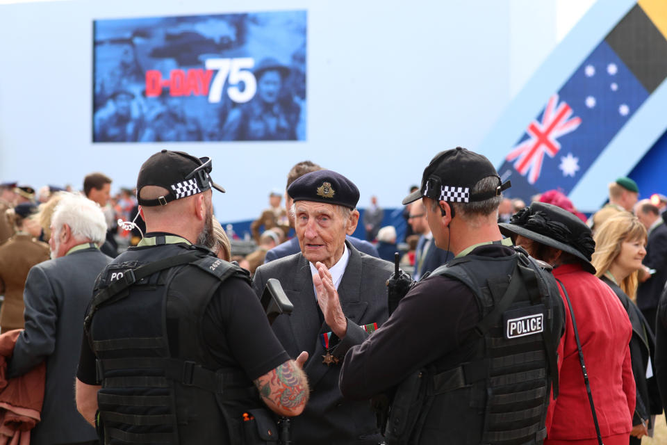 D-Day veteran Jim Booth, 97, speaks to armed police officers during the commemorations for the 75th Anniversary of the D-Day landings at Southsea Common in Portsmouth.