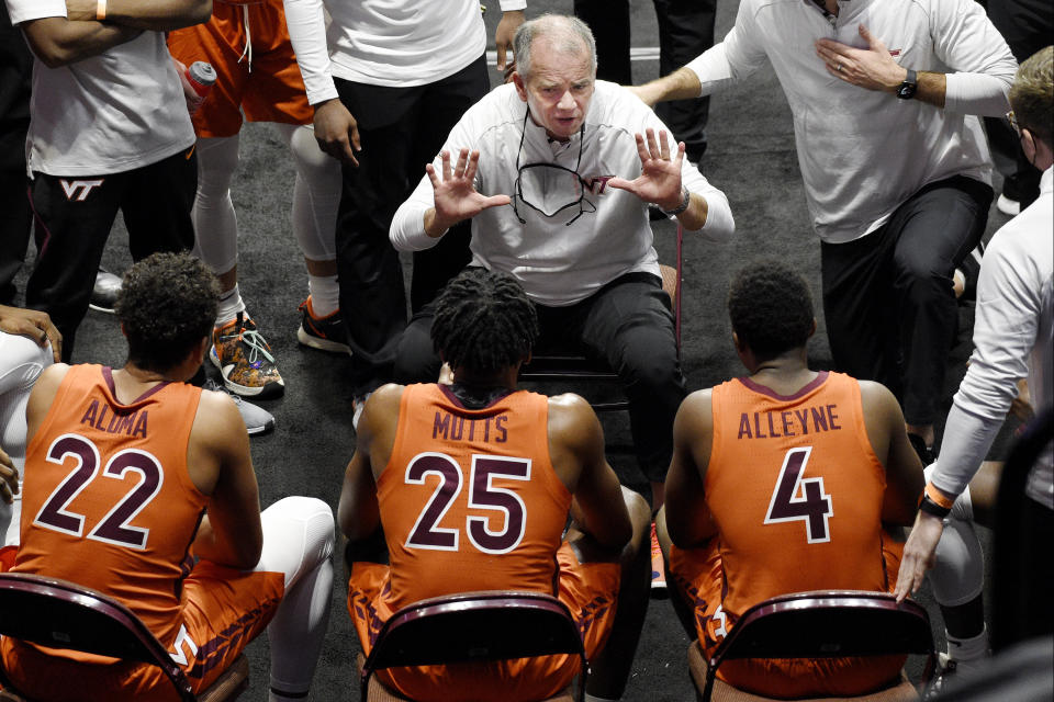 Virginia Tech's Mike Young, center top, talks to his team during a timeout in the first half of an NCAA college basketball game against Villanova, Saturday, Nov. 28, 2020, in Uncasville, Conn. (AP Photo/Jessica Hill)