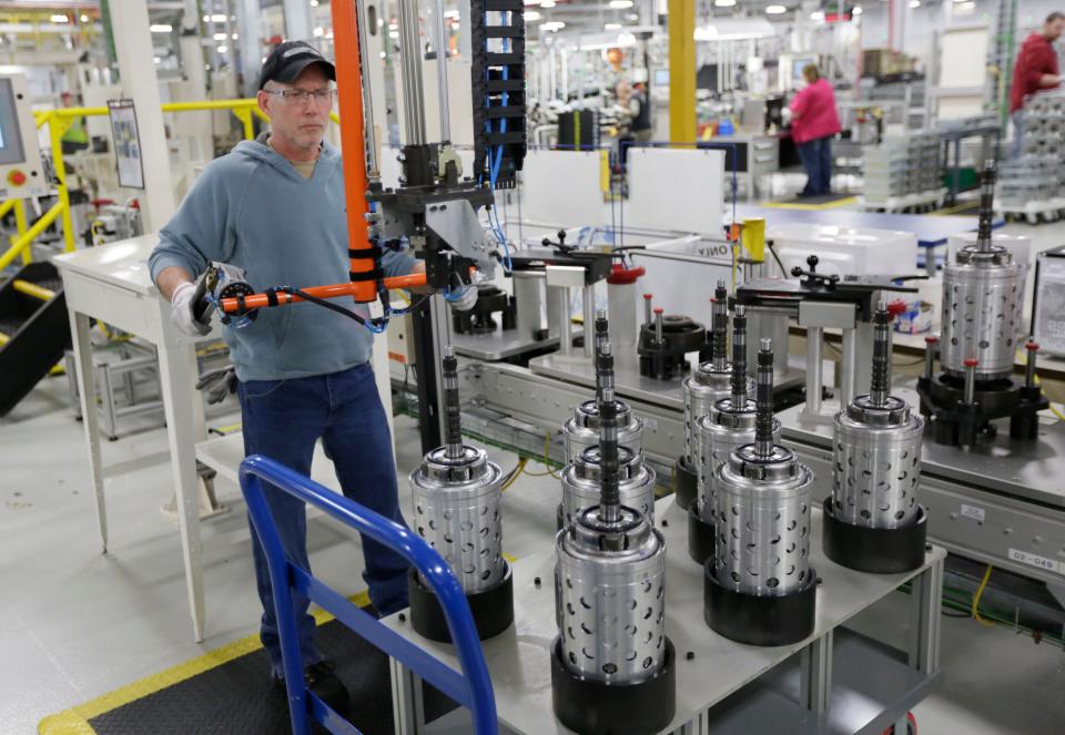 Dietz Werland works on the assembly line during a media tour before an investment and jobs announcement event at the Chrysler transmission plant in Kokomo, Ind. on Feb. 28, 2013. A House bill introduced Tuesday, Dec. 14, 2021, aims at centralizing federal manufacturing programs under a single website.