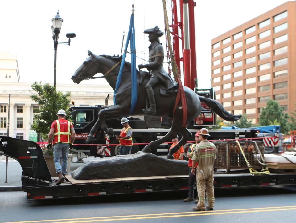 The statue of Caesar Rodney is hoisted from its pedestal on Rodney Square in Wilmington on June 12, 2020.