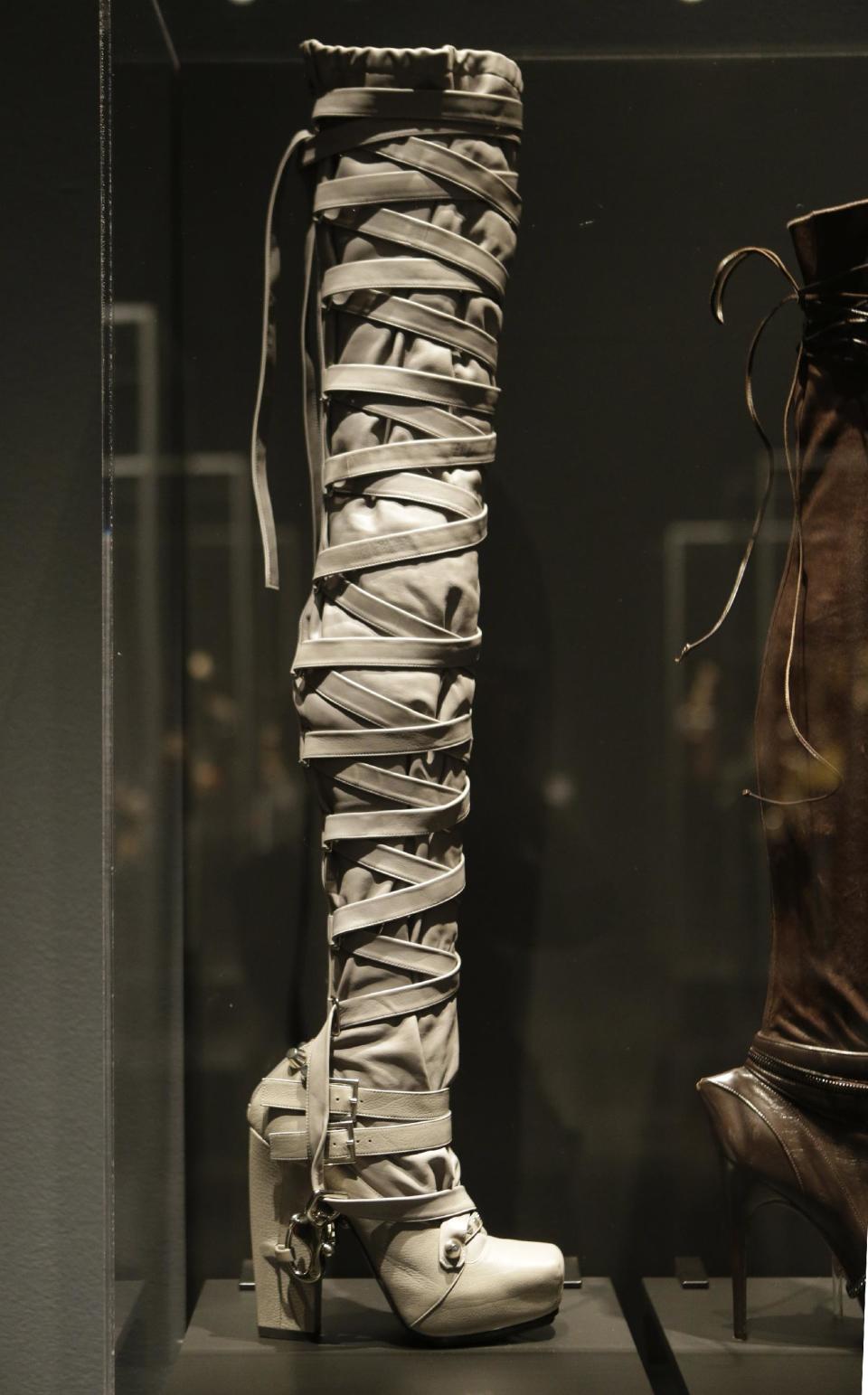 This Feb. 11, 2013 photo shows a thigh-high boot designed by Nicholas Kirkwood for the Rodarte spring 2009 fashion show at the "Shoe Obsession" exhibit at The Museum at the Fashion Institute of Technology Museum in New York. The exhibition, showing off 153 specimens, runs through April 13. (AP Photo/Kathy Willens)