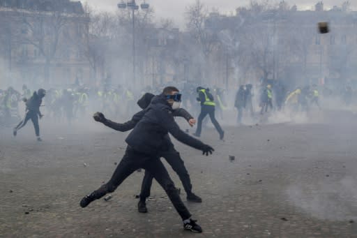 Masked rioters fought pitched battles with riot police by the Arc de Triomphe during the 'yellow vest' protests