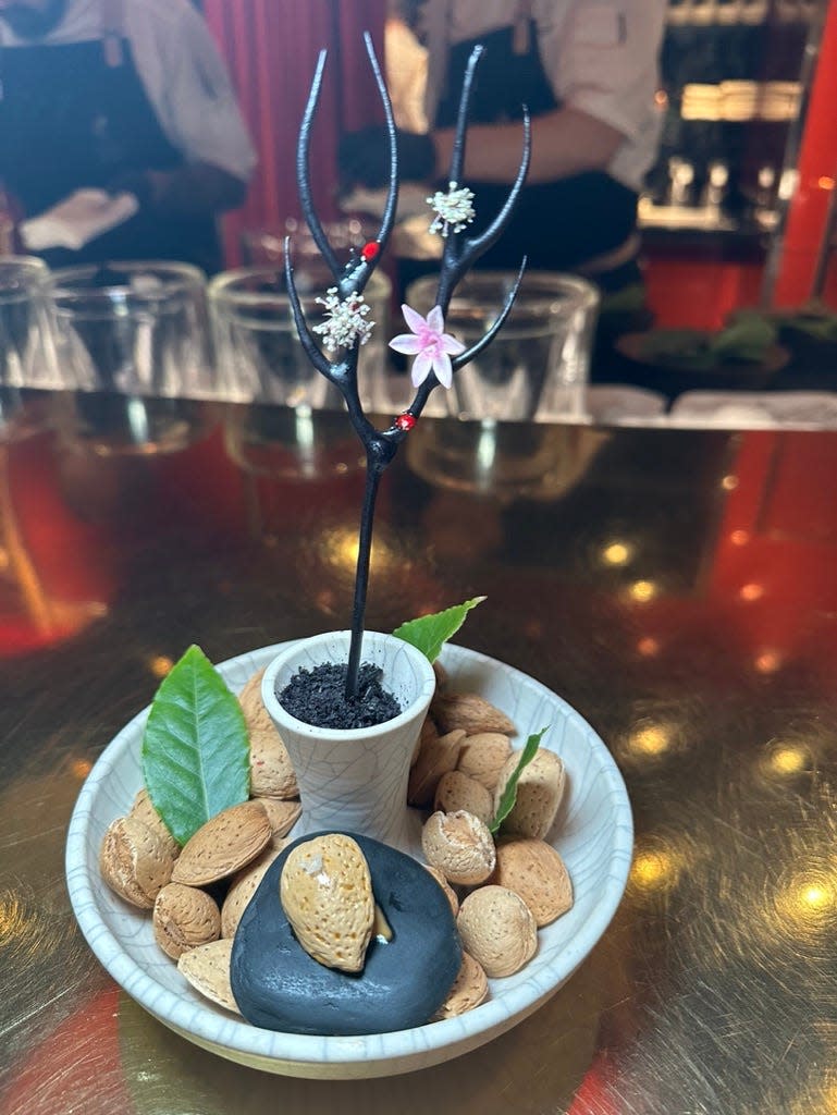 é by José Andrés Image 6: Our first dish was called Branches of the Desert” and had an avant-garde Marcona almond centerpiece