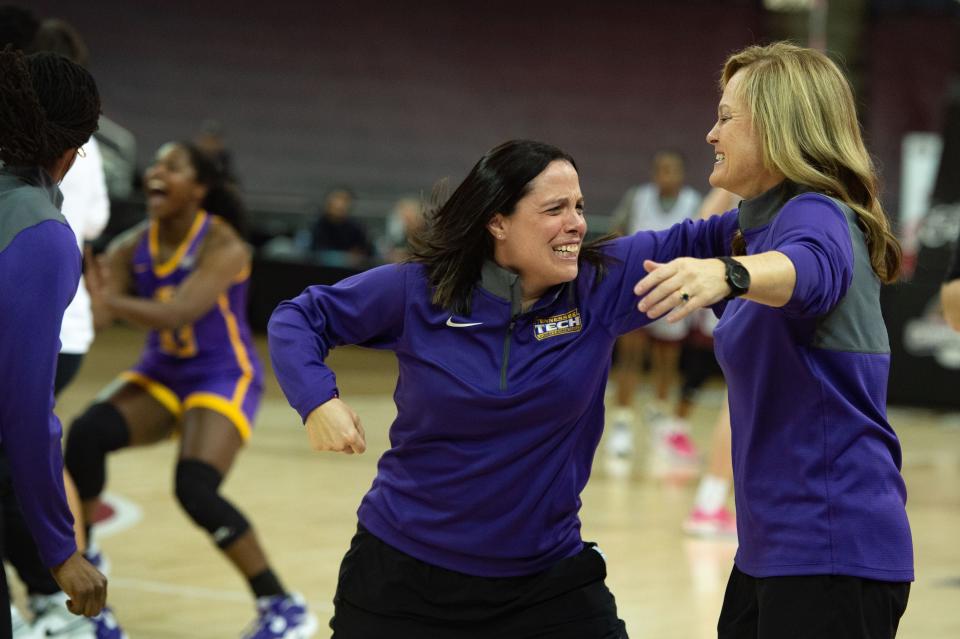 Tennessee Tech Assistant Coach Allison Clark, left, reaches to embrace Head Coach Kim Rosamond, right, just seconds following the Golden Eagles winning the OVC women's championship at Ford Center on Saturday, March 4, 2023.