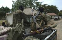 South Sudanese People Liberation Army (SPLA) soldiers sit on a pick up truck during a patrol in Malakal on January 21, 2014