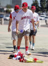 Angel fans, front to back, Reza Agahi, Grant Gaynor, both of Anaheim and William St.Marseille of Orange leave flowers at a"nmemorial outside Angel Stadium in Anaheim on Monday, July 1, 2019 in memory of Angel pitcher Tyler Skaggs who died in Texas at the age of 27. (Photo by Leonard Ortiz/MediaNews Group/Orange County Register via Getty Images)