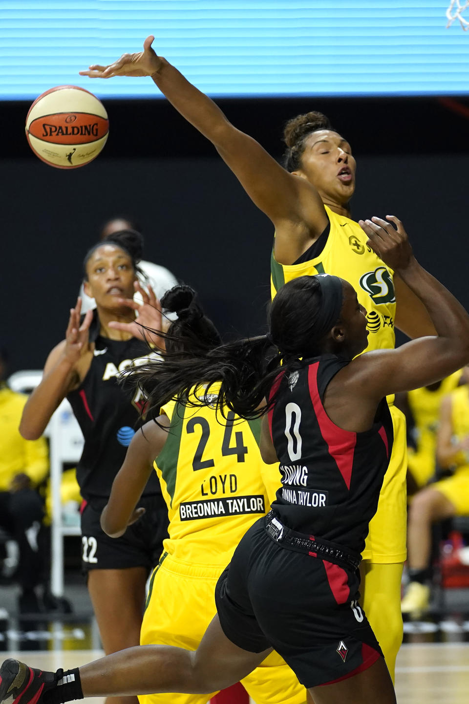 Seattle Storm center Mercedes Russell (2) blocks a shot by Las Vegas Aces guard Jackie Young (0) during the first half of Game 1 of basketball's WNBA Finals Friday, Oct. 2, 2020, in Bradenton, Fla. (AP Photo/Chris O'Meara)