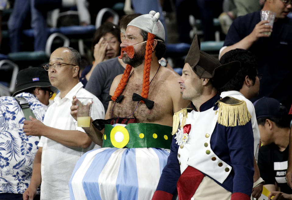 Spectators watch as players wave to the crowd following the Rugby World Cup Pool C game at Kumamoto Stadium between France and Tonga in Kumamoto, Japan, Sunday, Oct. 6, 2019. (AP Photo/Aaron Favila)