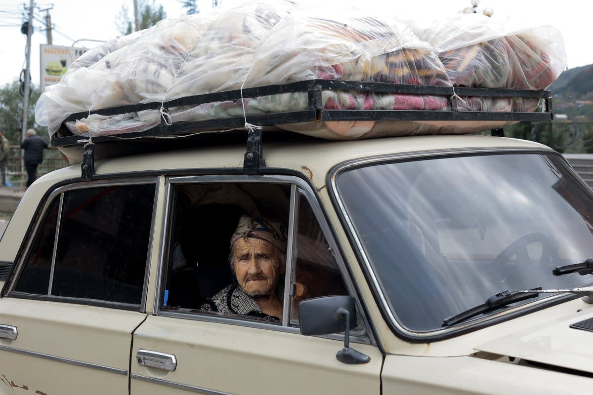 An ethnic Armenian woman from Nagorno-Karabakh sits inside an old Soviet-style car as she arrives in Goris, in Syunik region, Armenia (AP)