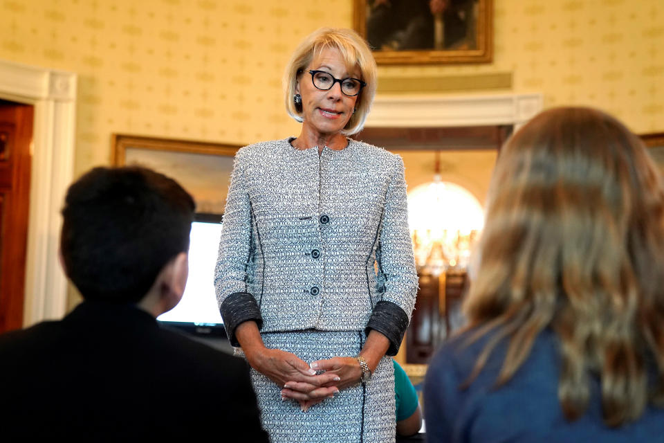 U.S. Secretary of Education Betsy DeVos speaks with school children during a listening session before the arrival of U.S. first lady Melania Trump at the White House in Washington, U.S., April 9, 2018.      REUTERS/Joshua Roberts