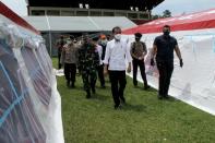 Indonesian President Joko Widodo inspects temporary shelters for displaced people affected by the earthquake at Manakarra stadium in Mamuju