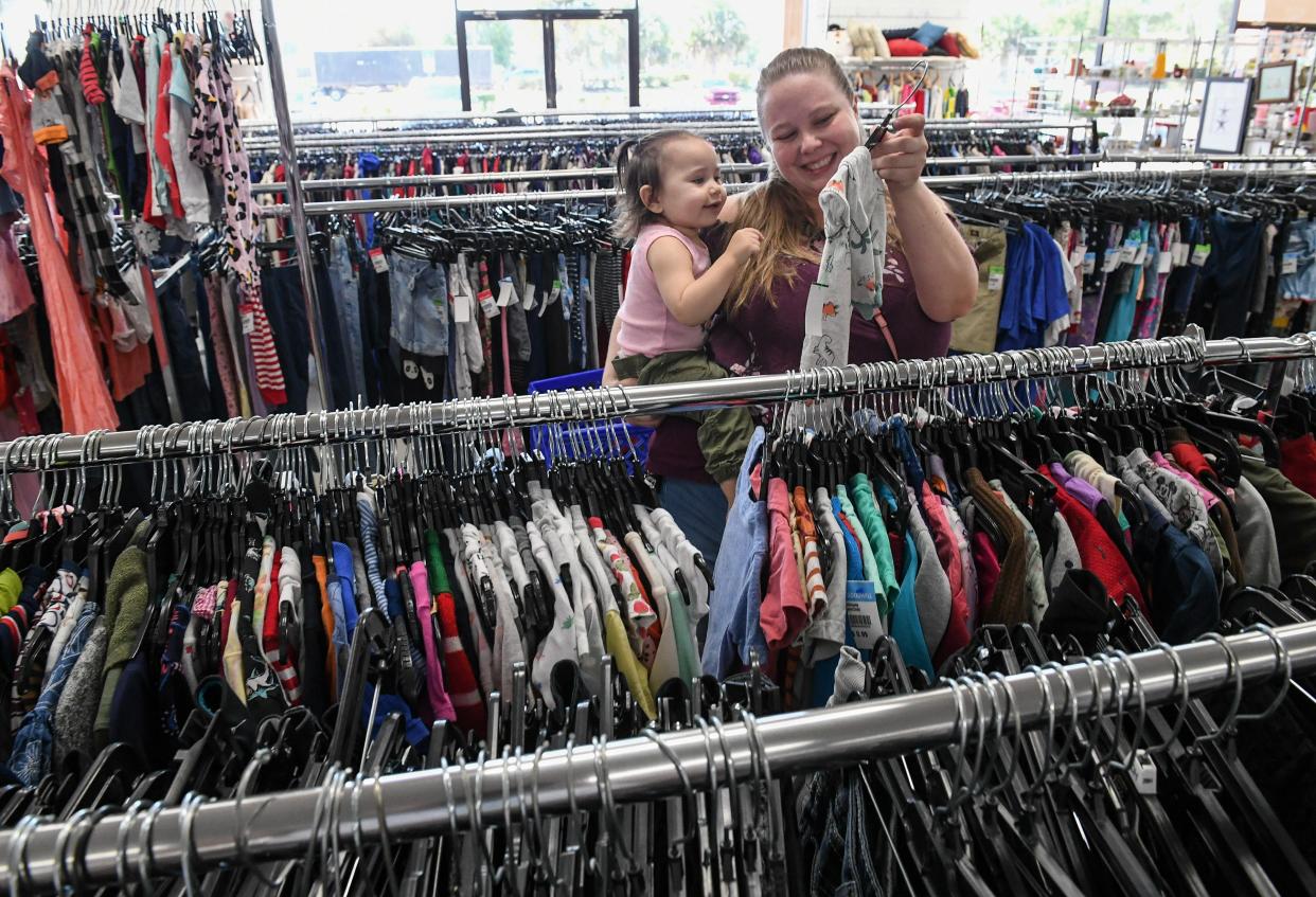 Jaclyn Hendricks, of Port St. Lucie shops with her daughter Jade, 22 months, inside the Goodwill store, one of the current tenants of the outlet mall, on Friday, March 15, 2024, in Fort Pierce. "The location and good deals for kid's clothes," Hendricks said about shopping at Goodwill store on the west end of the outlet mall.