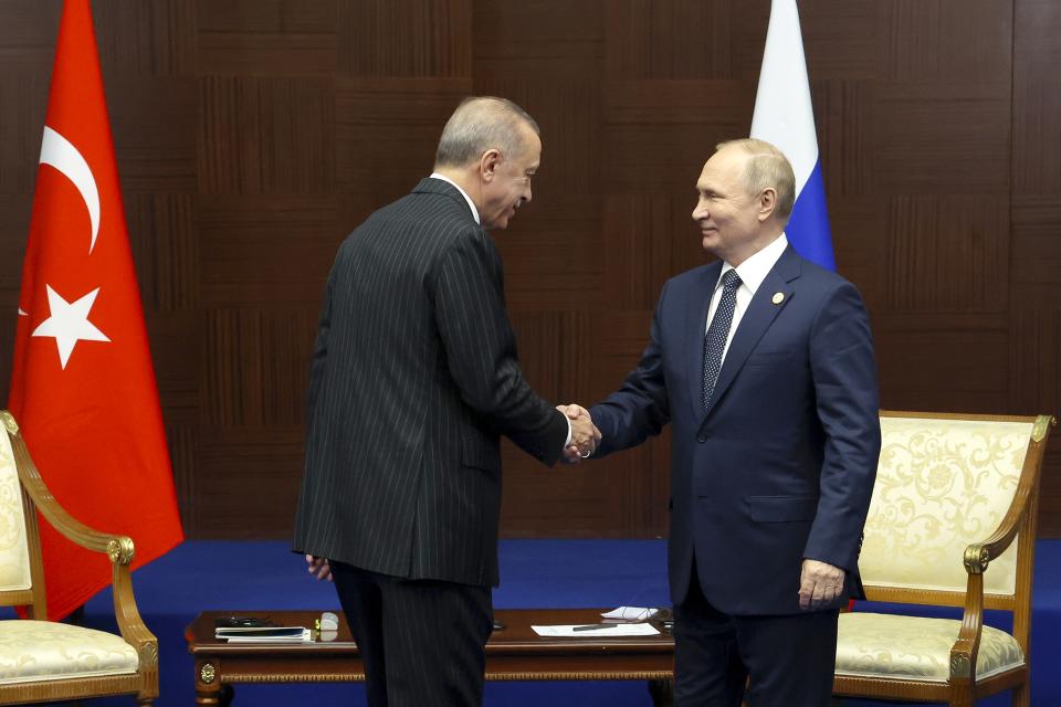 Russian President Vladimir Putin, right, and Turkey's President Recep Tayyip Erdogan shake hands during their meeting on sidelines of the Conference on Interaction and Confidence Building Measures in Asia (CICA) summit, in Astana, Kazakhstan, Thursday, Oct. 13, 2022. (Vyacheslav Prokofyev, Sputnik, Kremlin Pool Photo via AP)