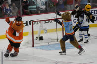Hockey mascots celebrate after Stanley C. Panther scores a goal during the NHL All Star Skills Showcase, Friday, Feb. 3, 2023, in Sunrise, Fla. (AP Photo/Lynne Sladky)