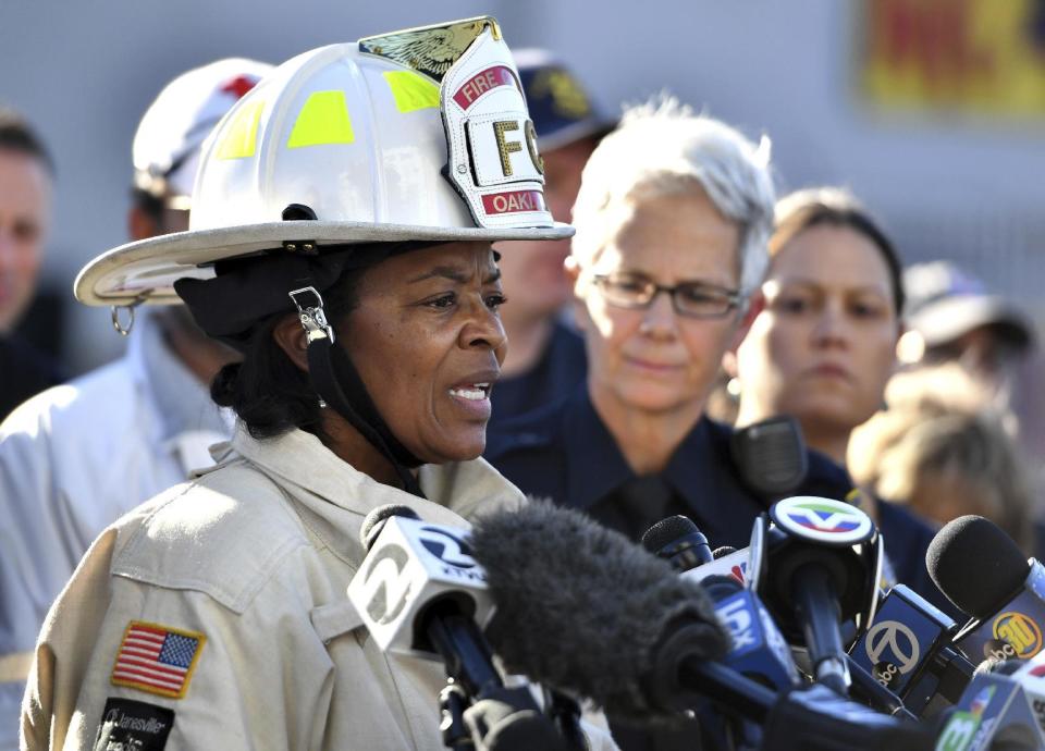 FILE - In this Dec. 3, 2016, file photo, Oakland Fire Chief Teresa Deloach Reed speaks to members of the media after a deadly fire tore through a warehouse during a late-night electronic music party in Oakland, Calif. Authorities say complaints mounted about the cluttered artists' warehouse in Oakland before a deadly blaze ripped through earlier this month. But Oakland Fire Chief Teresa Deloach Reed says Tuesday, Dec. 13, 2016, there are no city records showing her department received concerns about the building. Former residents, neighbors and others say the warehouse was the subject of numerous calls to 911. Thirty-six people died in the Dec. 2 fire. (AP Photo/Josh Edelson, File)