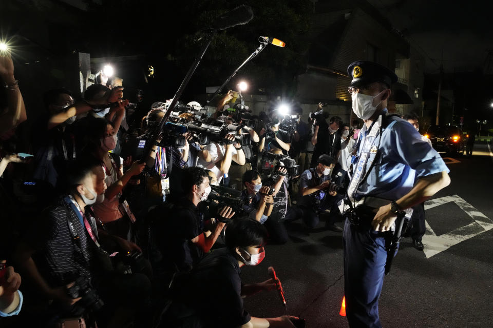 Journalists gather at the Poland Embassy to report on Belarusian athlete Krystsina Tsimanouskaya after she visited the embassy in Tokyo, Japan, Monday, Aug. 2, 2021. Tsimanouskaya, a Belarusian Olympic sprinter plans to seek asylum in Poland after alleging that officials tried to force her home, where she feared for her safety, an activist group said Monday. (AP Photo/Eugene Hoshiko)