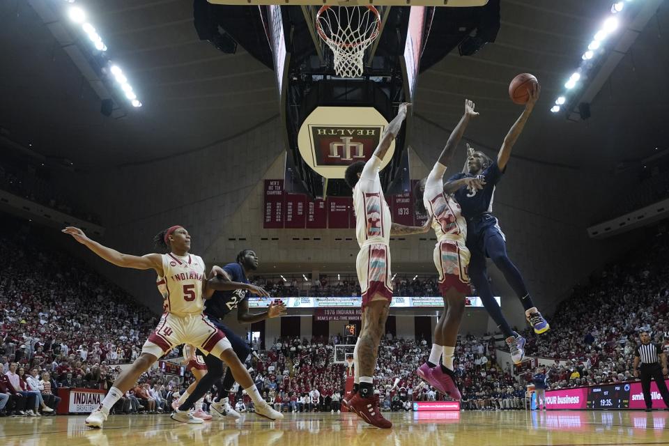 Penn State's Nick Kern Jr. (3) puts up a shot over Indiana's Mackenzie Mgbako (21) during the first half of an NCAA college basketball game, Saturday, Feb. 3, 2024, in Bloomington, Ind. (AP Photo/Darron Cummings)