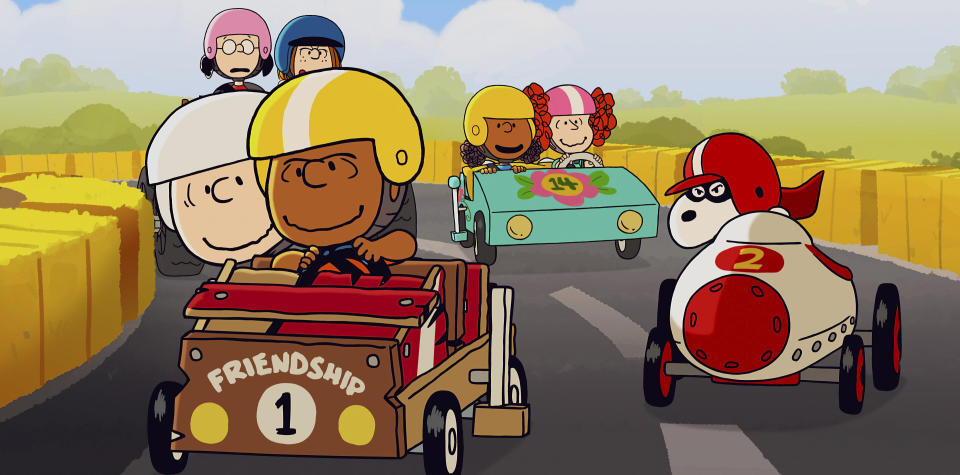 This image released by Apple TV+ shows Peanuts characters Charlie Brown, left, riding with Franklin as Snoopy follows at right, in a scene from the animated special “Snoopy Presents: Welcome Home, Franklin," premiering Friday. (Apple TV+ via AP)