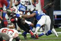 Tampa Bay Buccaneers' Ronald Jones (27) is tackled by Indianapolis Colts' Bobby Okereke (58) during the first half of an NFL football game, Sunday, Nov. 28, 2021, in Indianapolis. (AP Photo/AJ Mast)