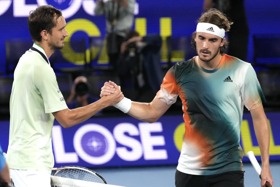 Daniil Medvedev, left, of Russia is congratulated by Stefanos Tsitsipas of Greece following their semifinal match at the Australian Open tennis championships in Melbourne, Australia, Friday, Jan. 28, 2022. (AP Photo/Simon Baker)