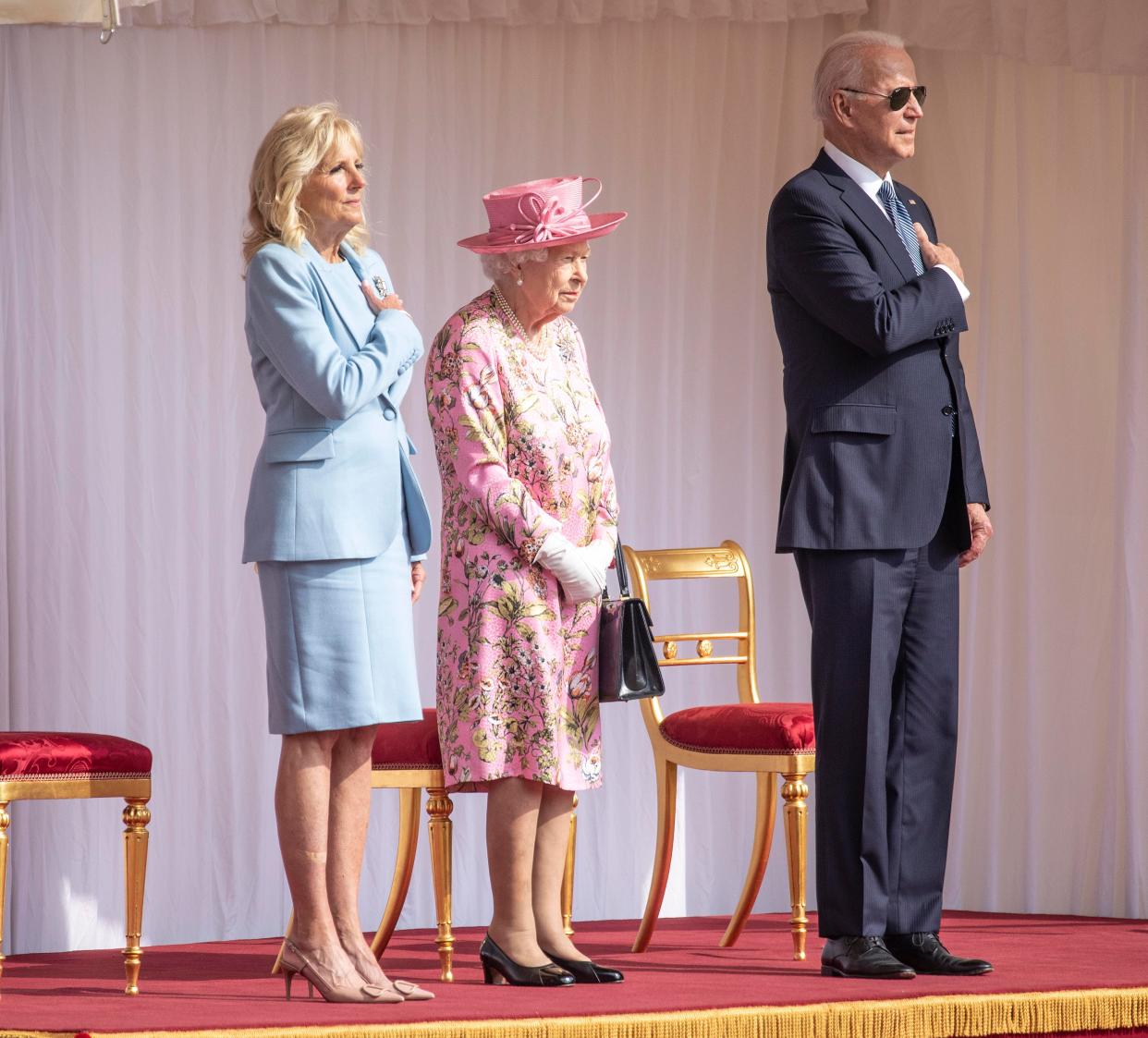 President Joe and Dr. Jill Biden stand with Queen Elizabeth.