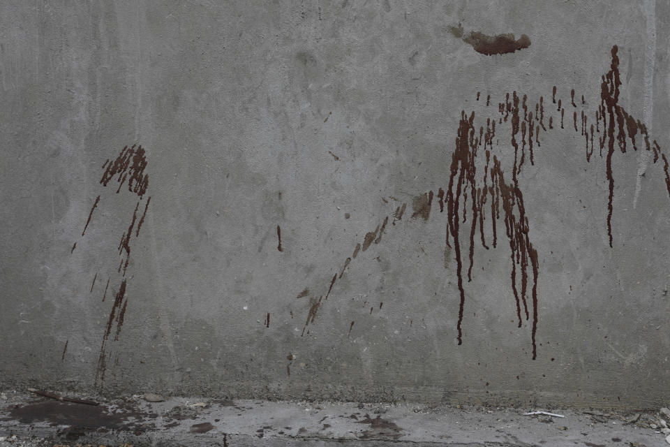 Blood covers a wall in the Petion-ville area of Port-au-Prince, Haiti, Wednesday, March 20, 2024. (AP Photo/Odelyn Joseph)