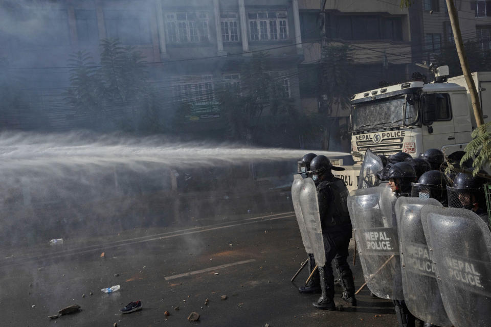 Nepalese police use water cannon to disperse protestors demanding a restoration of Nepal's monarchy in Kathmandu, Nepal, Thursday, Nov. 23, 2023. Riot police used batons and tear gas to halt tens of thousands of supporters of Nepal's former king demanding the restoration of the monarchy and the nation's former status as a Hindu state. Weeks of street protests in 2006 forced then King Gyanendra to abandon his authoritarian rule and introduce democracy. (AP Photo/Niranjan Shrestha)