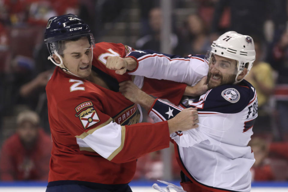 Florida Panthers defenseman Josh Brown (2) and Columbus Blue Jackets left wing Nick Foligno, right, trade blows during the first period of an NHL hockey game, Saturday, Dec. 7, 2019, in Sunrise, Fla. (AP Photo/Lynne Sladky)