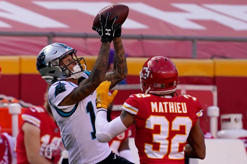 Carolina Panthers wide receiver Robby Anderson, left, catches a pass against Kansas City Chiefs strong safety Tyrann Mathieu (32) during the second half of an NFL football game in Kansas City, Mo., Sunday, Nov. 8, 2020. (AP Photo/Jeff Roberson)