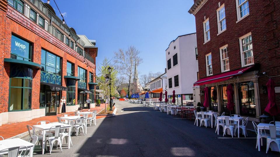 view from church lane in beautiful spring day with restaurans table outside
