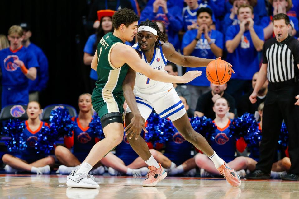 Boise State forward O'Mar Stanley, right, is defended by Colorado State forward Joel Scott (1) during the first half of an NCAA college basketball game Tuesday, Jan. 9, 2024, in Boise, Idaho. (AP Photo/Steve Conner)