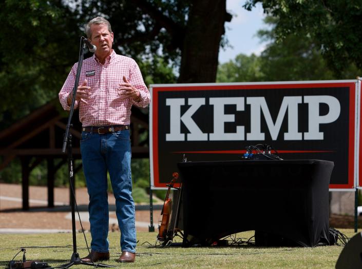 Georgia Gov. Brian Kemp, a large Kemp for Governor sign at his back, addresses supporters during a campaign rally in Watkinsville, Georgia.