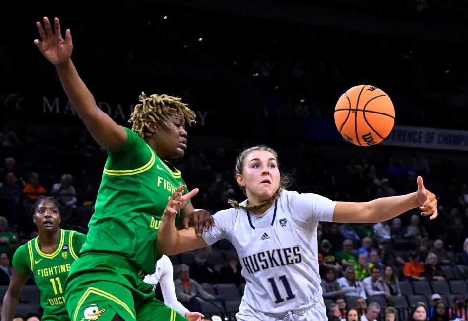 Oregon center Phillipina Kyei, left, and Washington forward Haley Van Dyke (11) vie for the ball during the second half of the game in the first round of the Pac-12 women's tournament Wednesday, March 1, 2023, in Las Vegas.