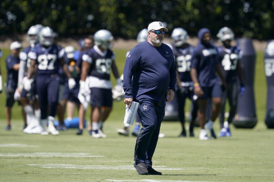 Dallas Cowboys head coach Mike McCarthy walks across the field as he watches workouts at the team's NFL football training facility in Frisco, Texas, Wednesday, Aug. 25, 2021. (AP Photo/Tony Gutierrez)