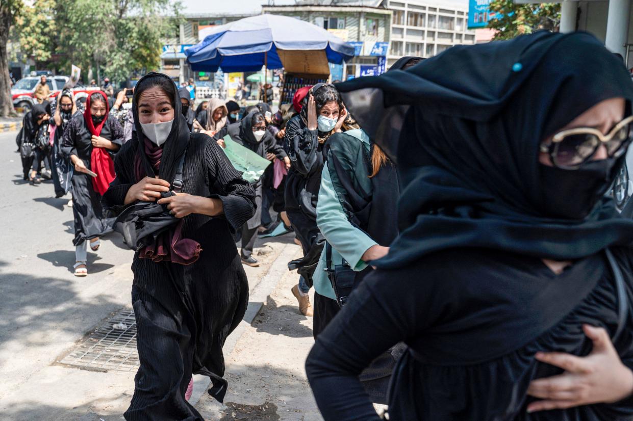 Taliban fighters fire into the air to disperse Afghan women protesters in Kabul on August 13, 2022. / Credit: WAKIL KOHSAR/AFP/Getty