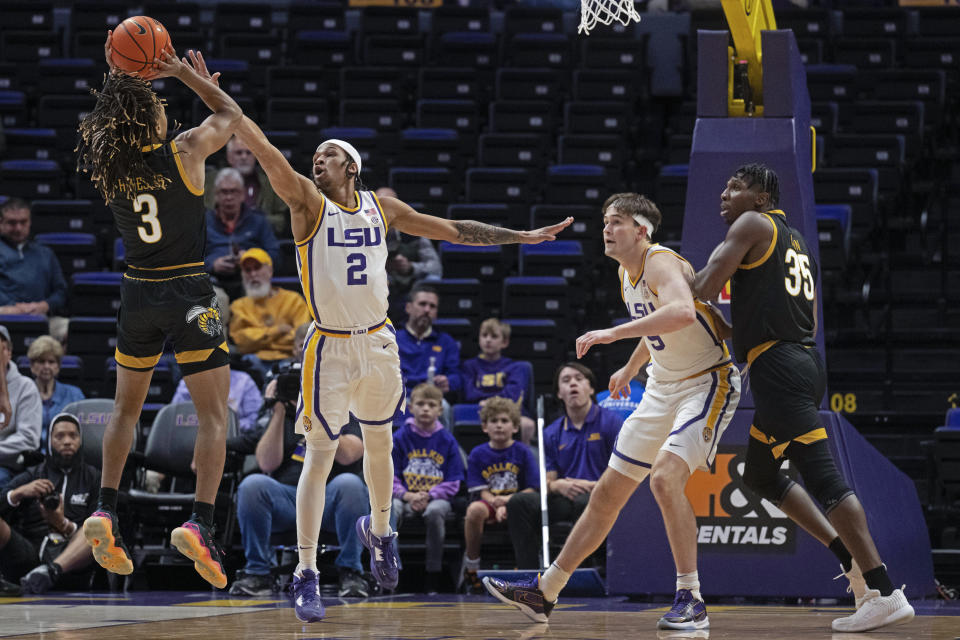 LSU guard Mike Williams III (2) defends against Alabama State guard CJ Hines (3) as LSU forward Will Baker (9) pushes back on Alabama State center Ubong Okon (35) during an NCAA college basketball game on Wednesday, Dec. 13, 2023, in Baton Rouge, La. (Hilary Scheinuk/The Advocate via AP)