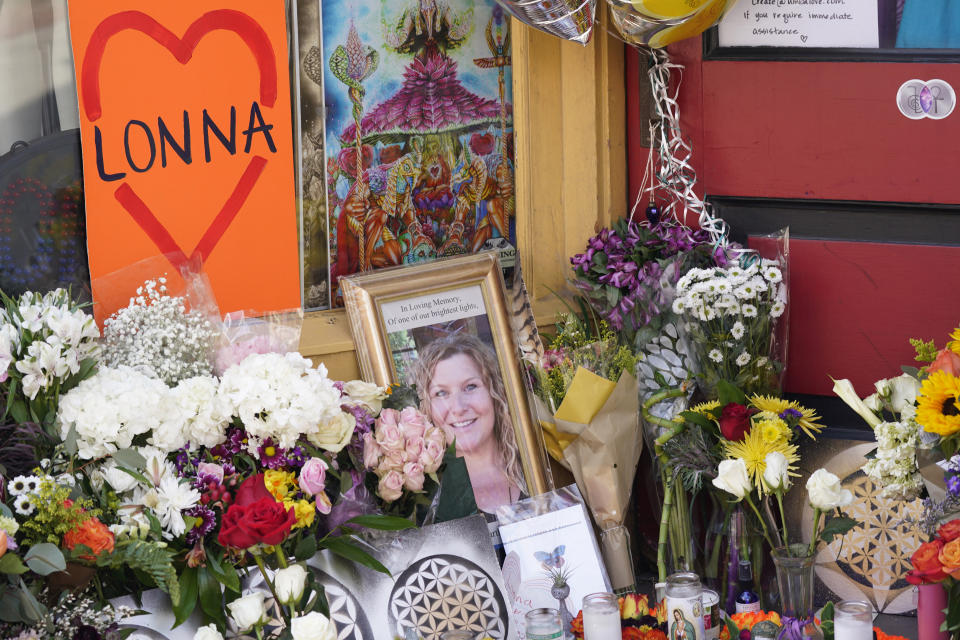 A tribute is displayed outside the store owned by one of 10 victims in the mass shooting at a King Soopers grocery store in Boulder, Colo., Wednesday, March 24, 2021, in Boulder, Colo. A shrine filled with candles and flowers kept growing Wednesday outside Umba Love, the clothing and accessories shop that victim Tralona Bartkowiak ran with her sister on Boulder’s popular Pearl Street Mall. Bartkowiak died in the supermarket shooting attack on Monday. (AP Photo/David Zalubowski)