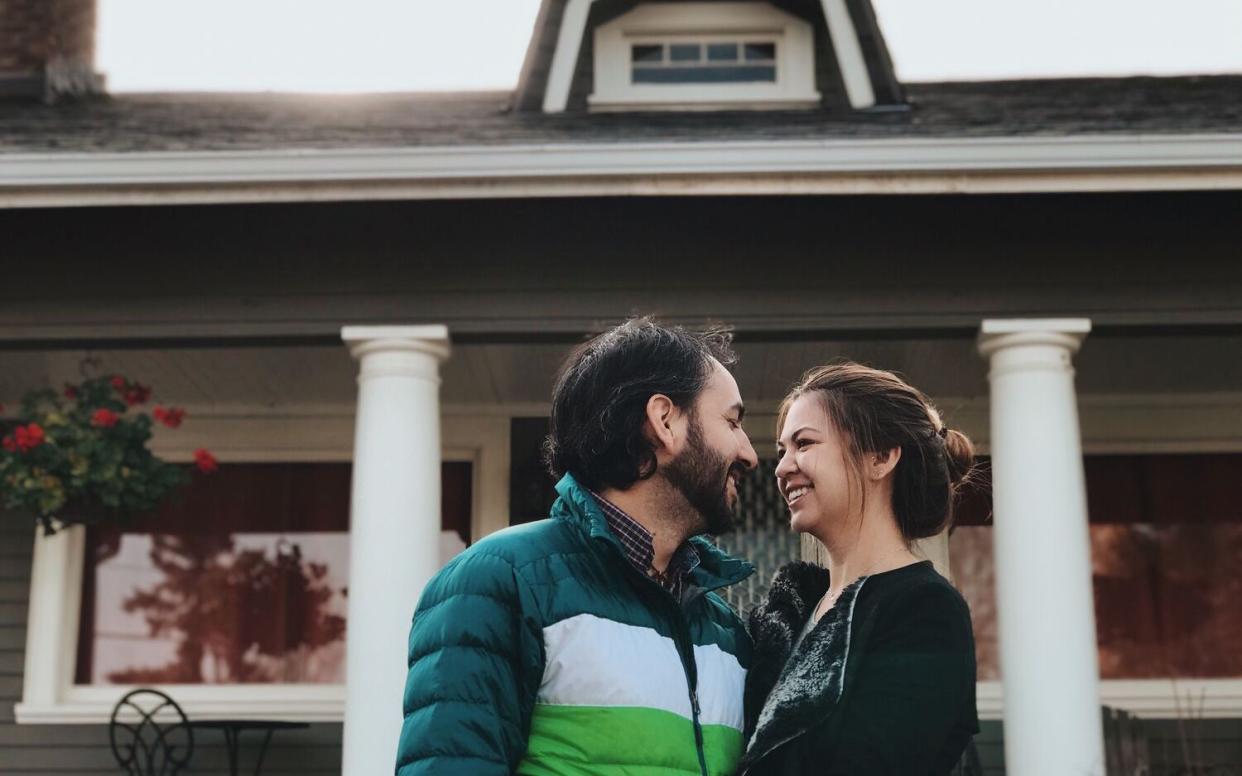 couple in front of new home