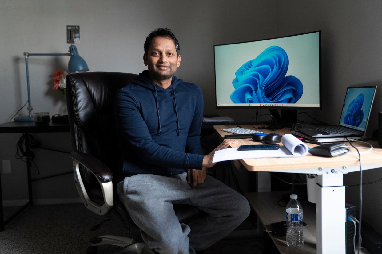 Shantanu Prakash, a tech worker on an H-1B visa, sits in the area of his Columbus home that he uses for work on Nov. 28, 2023. Prakash's family lives in India, but he is able to communicate with his son every day. Because of the nature of the H-1B visa, it is difficult for Prakash to make decisions that are dependent on the stability of his residency in the U.S.