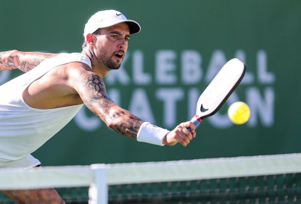 Professional player Tyson McGuffin returns the ball while playing mixed doubles during the Pro Pickleball Association Masters tournament at the La Quinta Resort and Club, Friday, Nov. 12, 2021, in La Quinta, Calif. 