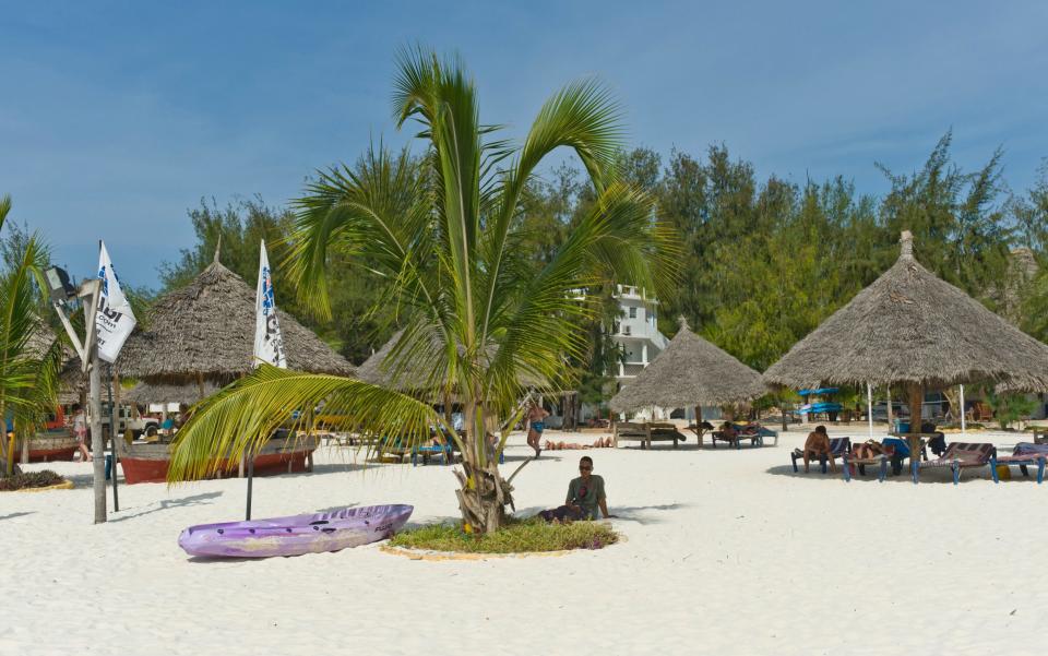Beach, palms and huts on the north coast of Zanzibar's Kendwa Rocks
