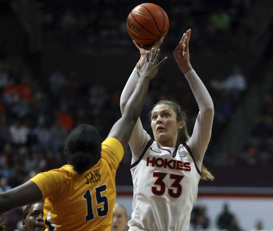 UNC-Greensboro's Khalis Cain (15) defends against Virginia Tech's Elizabeth Kitley (33) in the first half of an NCAA college basketball game in Blacksburg, Va., Monday, Nov. 20 2023. (Matt Gentry/The Roanoke Times via AP)