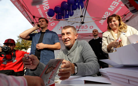 Mr Babis signs books for an ANO supporter during an election campaign rally in Prague. - Credit: David W Cerny/Reuters