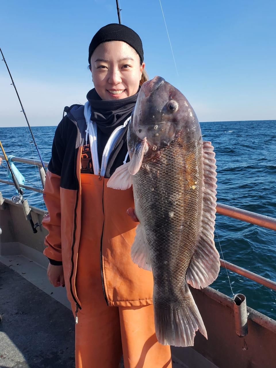 Hailey JiHye Kim of New York with a blackfish she landed on the Dauntless.