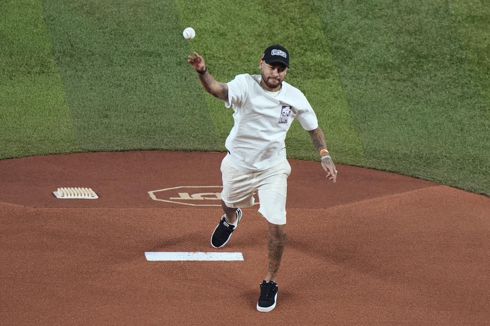 Brazilian soccer player Neymar throws out a ceremonial first pitch before the start of a baseball game between the Miami Marlins and the Pittsburgh Pirates, Thursday, March 28, 2024, in Miami. (AP Photo/Wilfredo Lee)