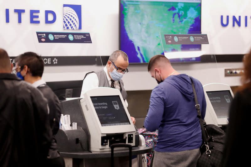 FILE PHOTO: Airline passenger checks in at the United airlines desk at the Tampa International Airport